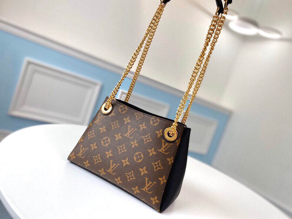 Brown monogram shoulder bag with black side panels and gold-tone chain straps