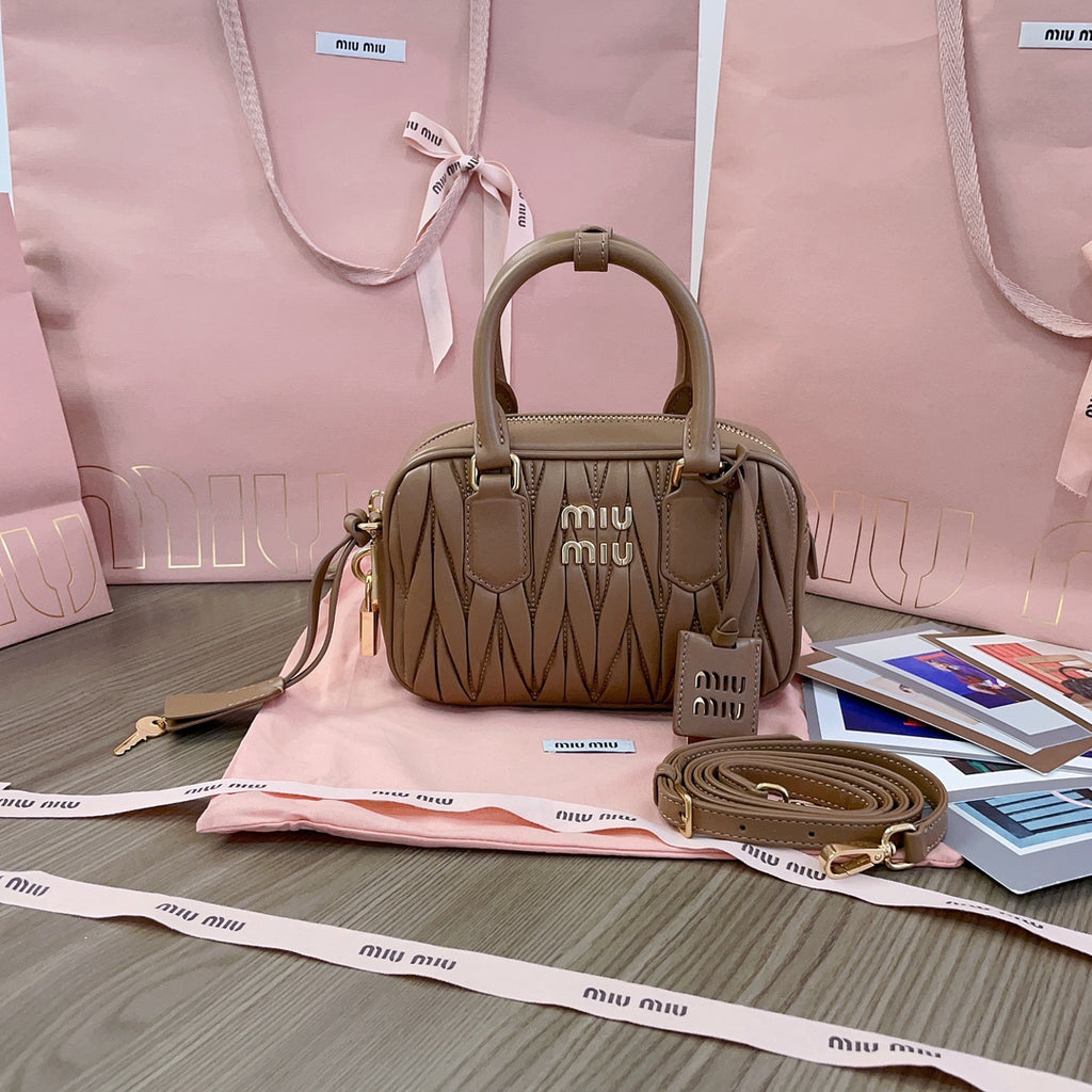 Taupe ruched bag with twin top handles and gold-tone zip detailing
