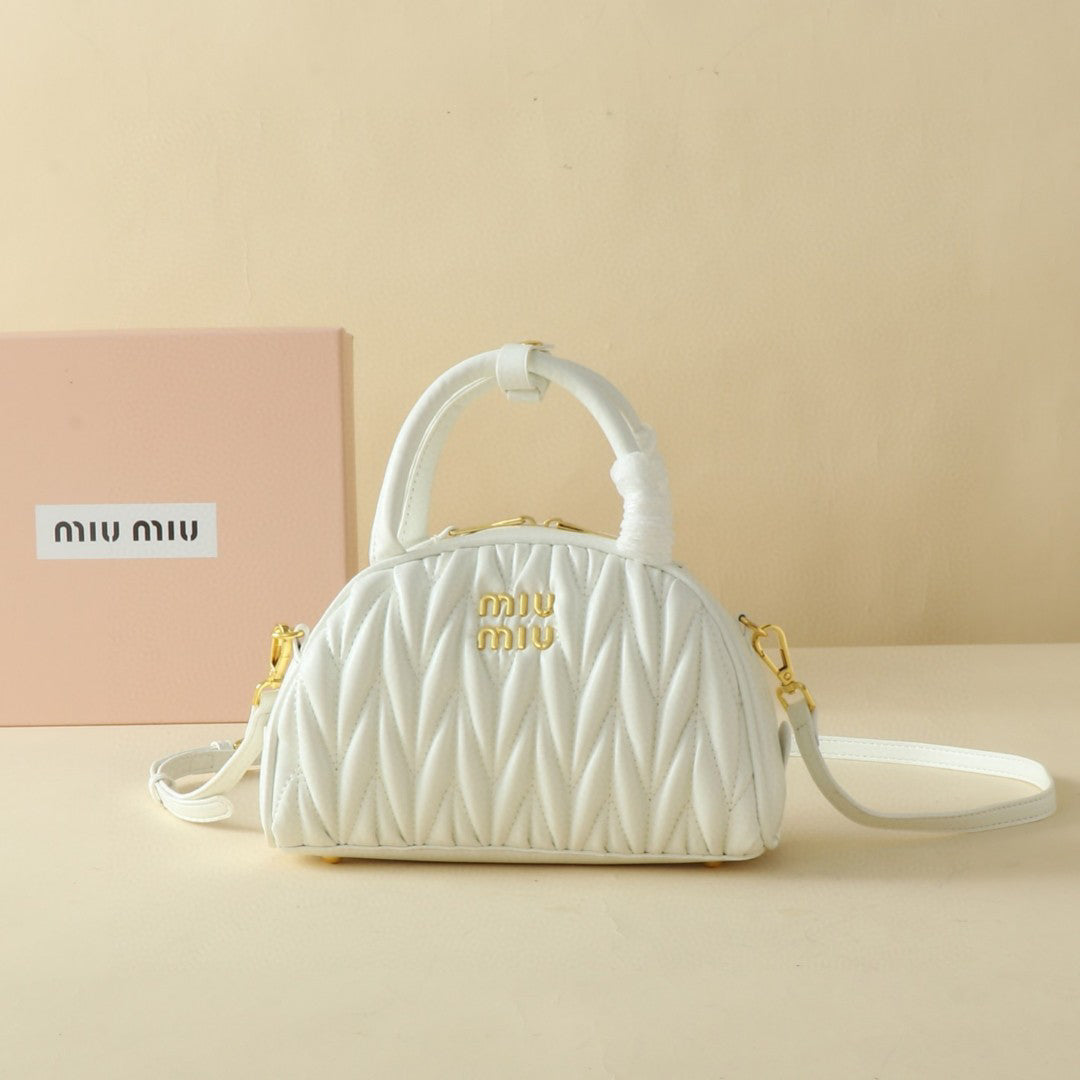 Ivory ruched dome-shaped bag with twin top handles, shoulder strap and gold-tone fittings