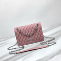 Dusty pink ruched shoulder bag with silver-tone chain strap and faceted decorative accents