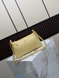 Pale yellow textured shoulder bag with zip-top design and gold-tone chain strap woven with matching material
